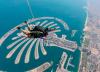 A contestant on The Amazing Race skydives in tandem over Palm Jumeirah in Dubai, UAE
