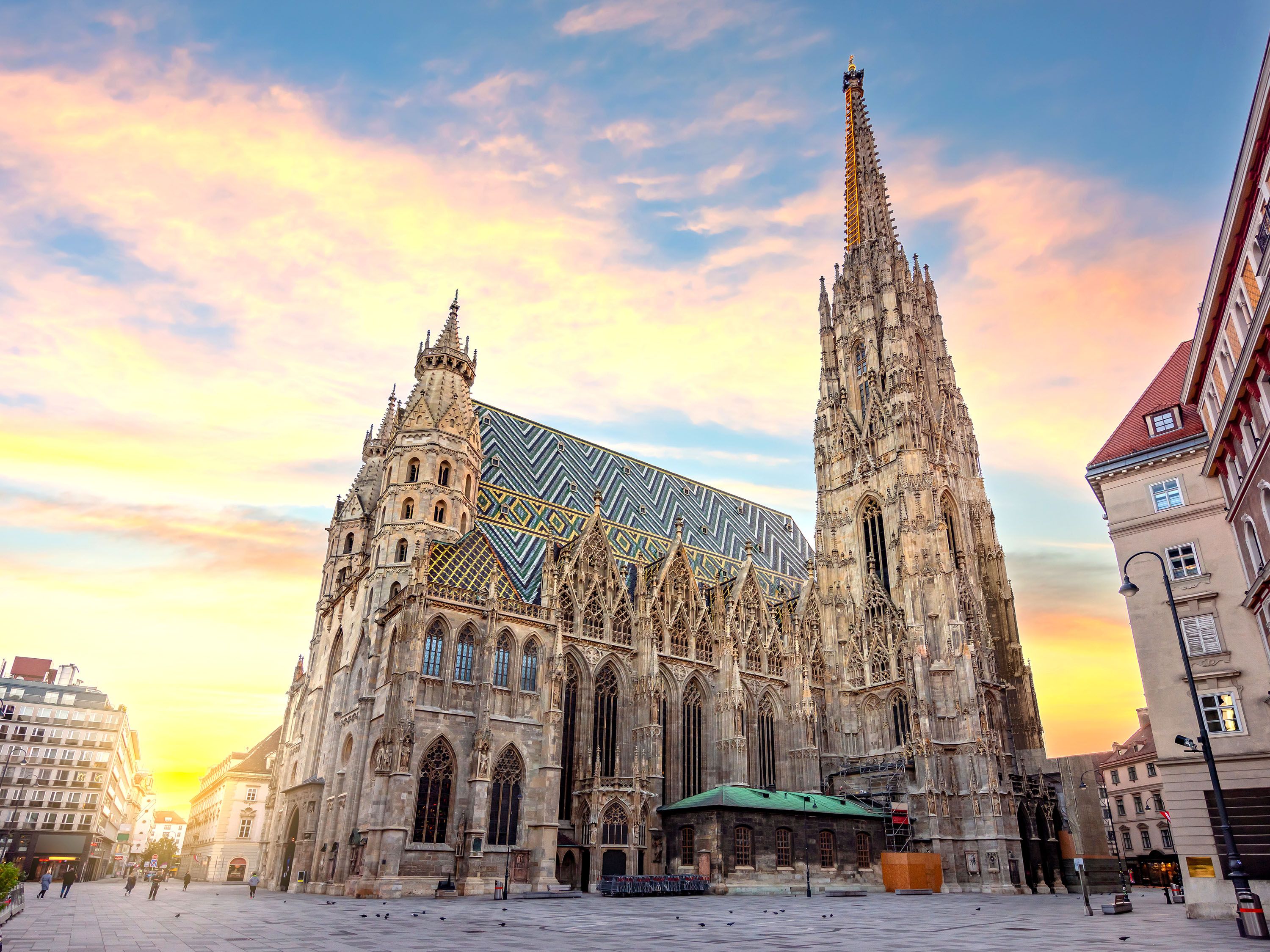 Sun set on a gothic church with steeple.