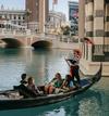 A family rides in a gondola on the water surrounding The Venetian hotel in Las Vegas, Nevada