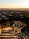 Evening hikers walk the trails in golden light at Runyon Canyon Park in Los Angeles, California