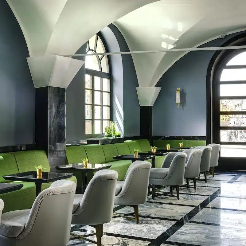 Grey and green seating in the marble-floored lobby at Hotel Balestri in Florence, Italy