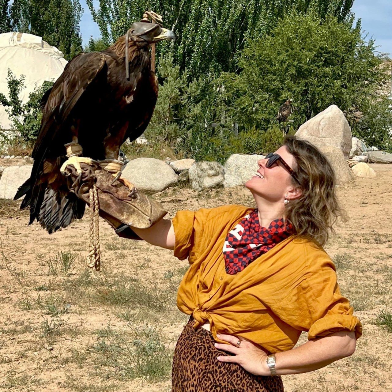 Photographer Jessica Antola with a huge eagle perched on her thick leather glove