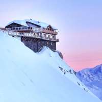 A luxury hotel sits at the top of a mountain in Courchevel, France