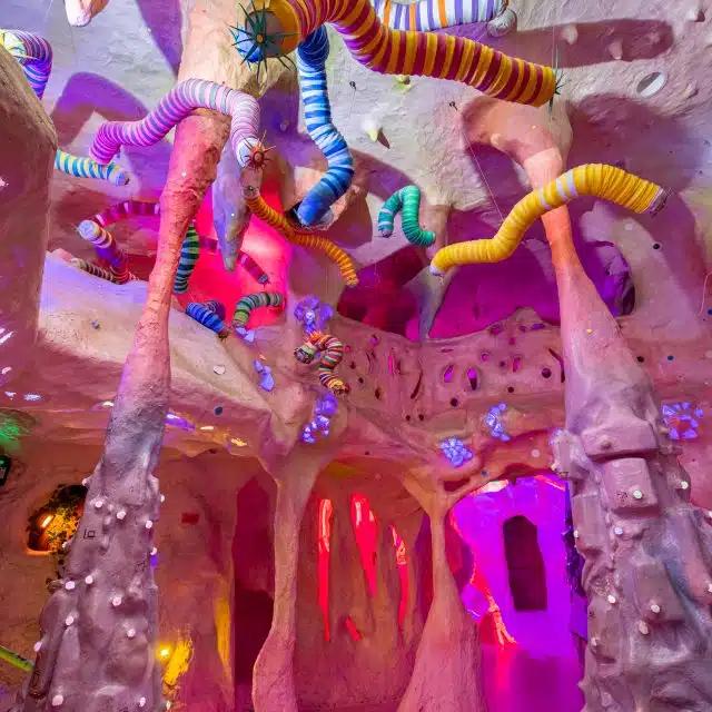 In shades of purple and pink, The Caves are just one of 70 mind-bending rooms