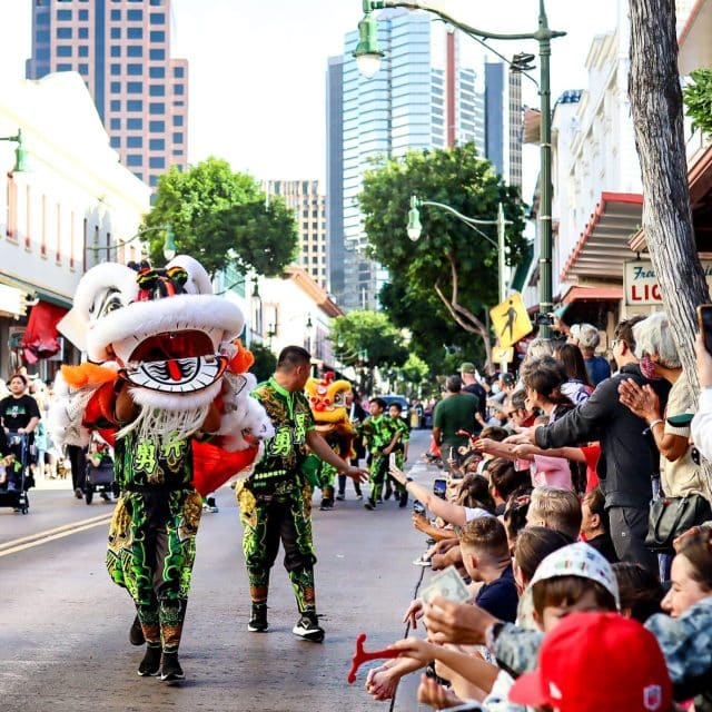 A Chinese lion parades a Honolulu street lined with cheering crowds as part of Lunar New Year celebrations