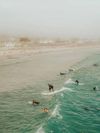 People surf at the beach in Santa Barbara, California