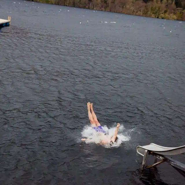 Ewan McGregor splashes into a loch from a metal slide, Taymouth Marina, Scotland