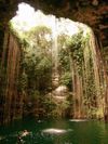 Light streams into Cenote Ik Kil, near Chichen Itza, onto swimmers below