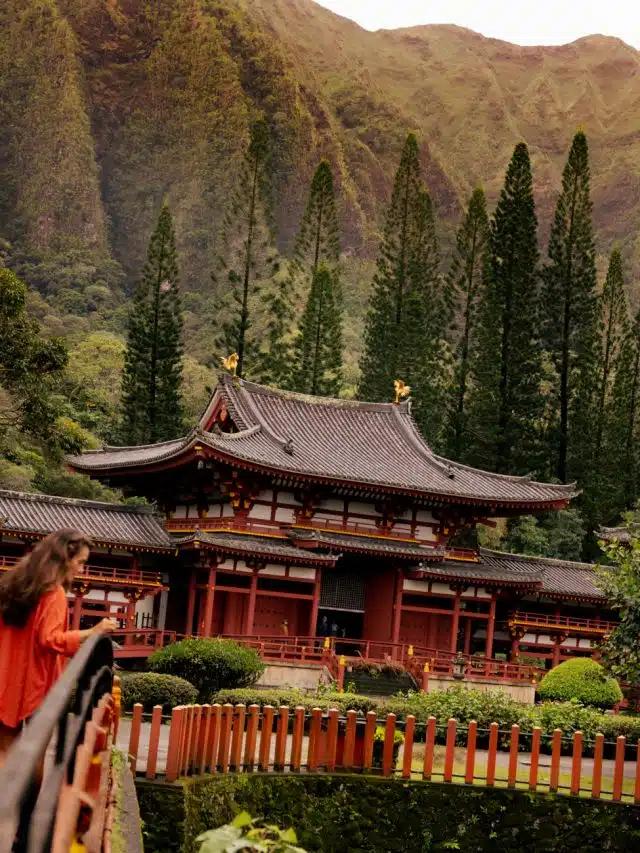 A woman peers over a bridge near the Byodo-In Temple, Kaneho