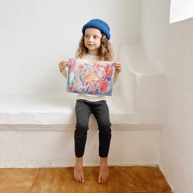 Rosie, daughter of artist Meghan Bustard, shows off her own artwork