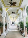 An ornate covered walkway through the Taj Mahal Palace hotel in Mumbai, India