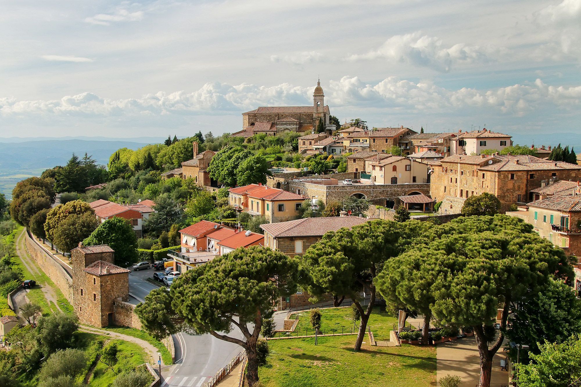 Aerial view of trees and buildings in Montalcino, Italy.
