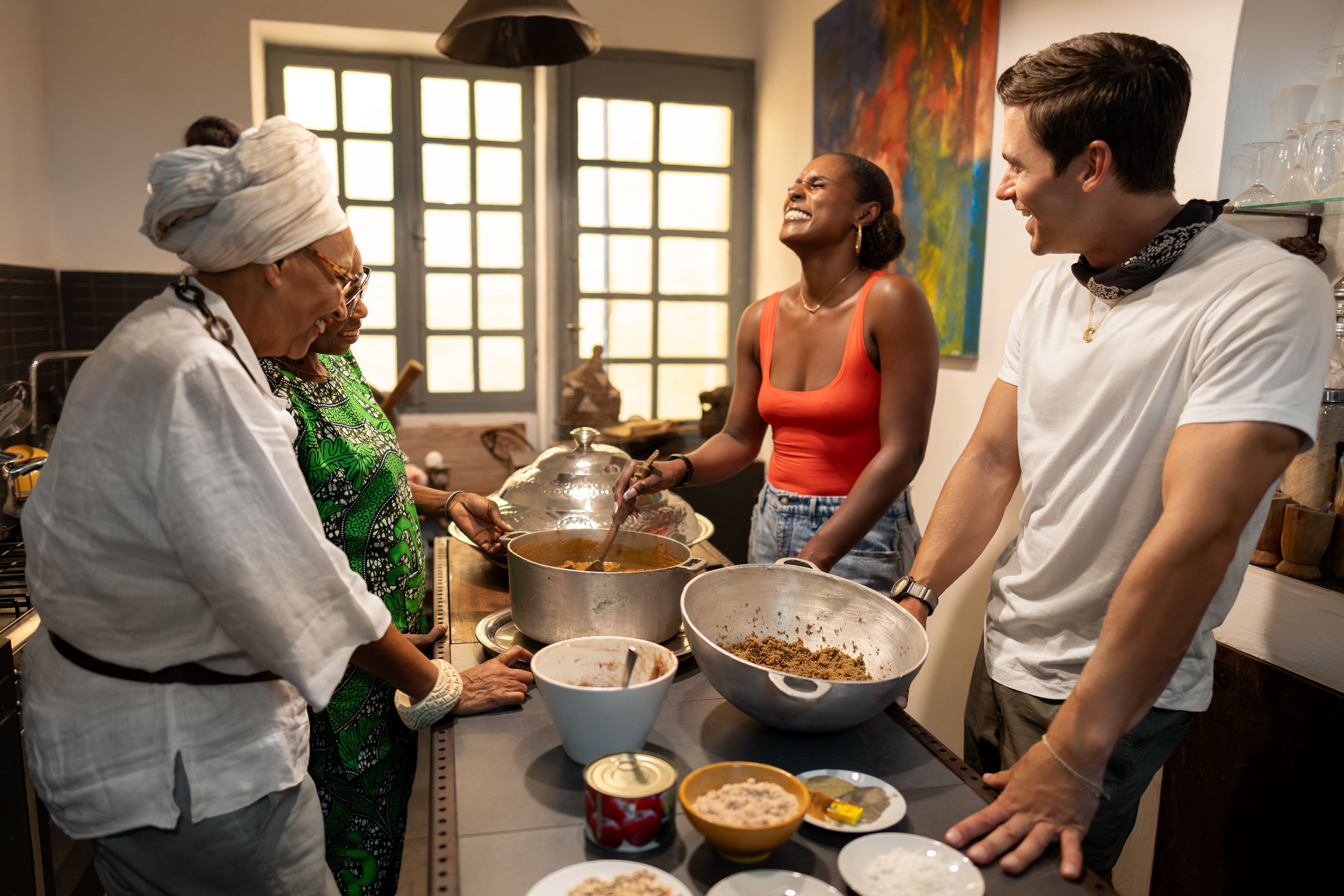 Antoni Porowski with Issa Rae, helping to prepare a traditional Senegalese dish. Photo: National Geographic/John Wendle