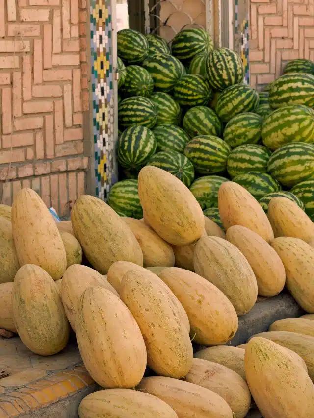 Two types of melons piled high against a doorway, Istaravshan Bazaar, Tajikistan