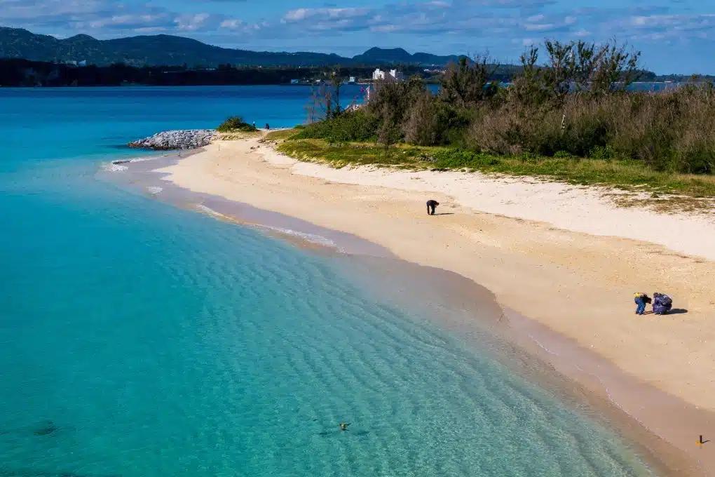 Turquoise waters lap the shore of Kouri Beach in Okinawa, Japan