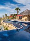 A narrow curving pool wrapping around a Vrbo in Todos Santos
