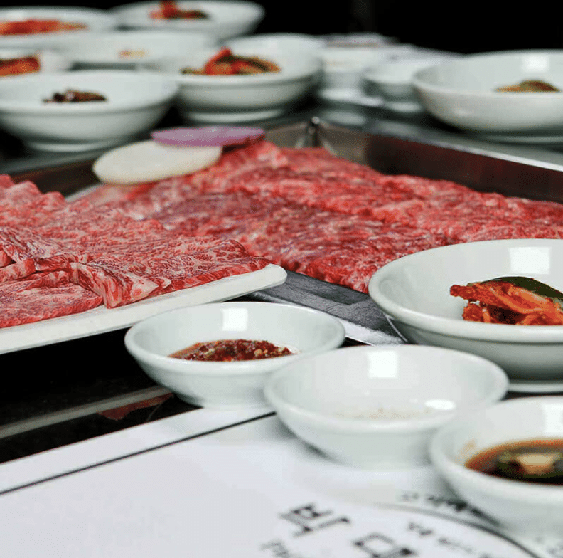 Plates of raw meat and sides at Park’s BBQ in Koreatown, Los Angeles