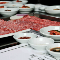 Plates of raw meat and sides at Park’s BBQ in Koreatown, Los Angeles