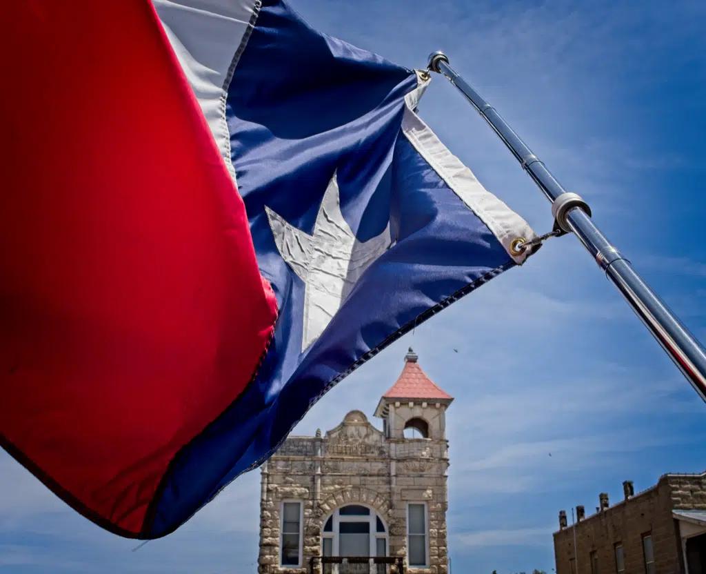 The state flag of Texas blowing in the wind in Fredericksburg, Texas