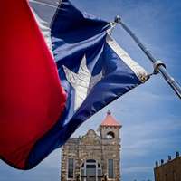 The state flag of Texas blowing in the wind in Fredericksburg, Texas