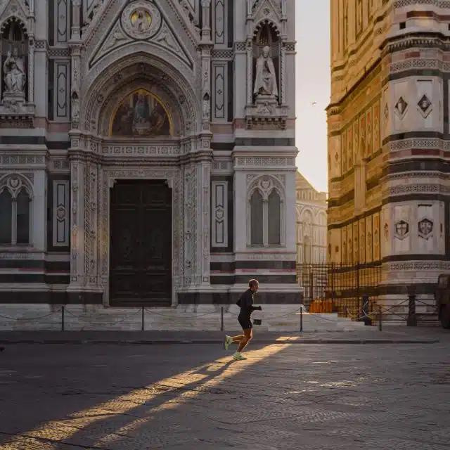 A person jogs past the Cathedral of Santa Maria del Fiore in Florence, Italy