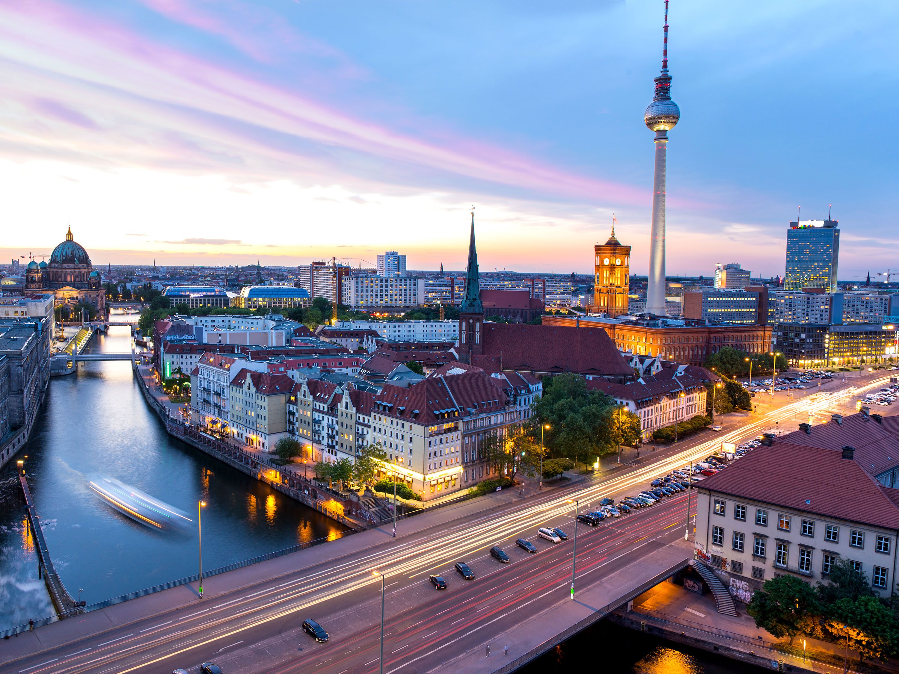 Aerial vew of a river and city buildings with a large spire.