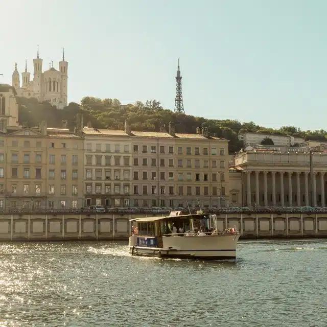 A boat cruising on the Saone river in Lyon, France