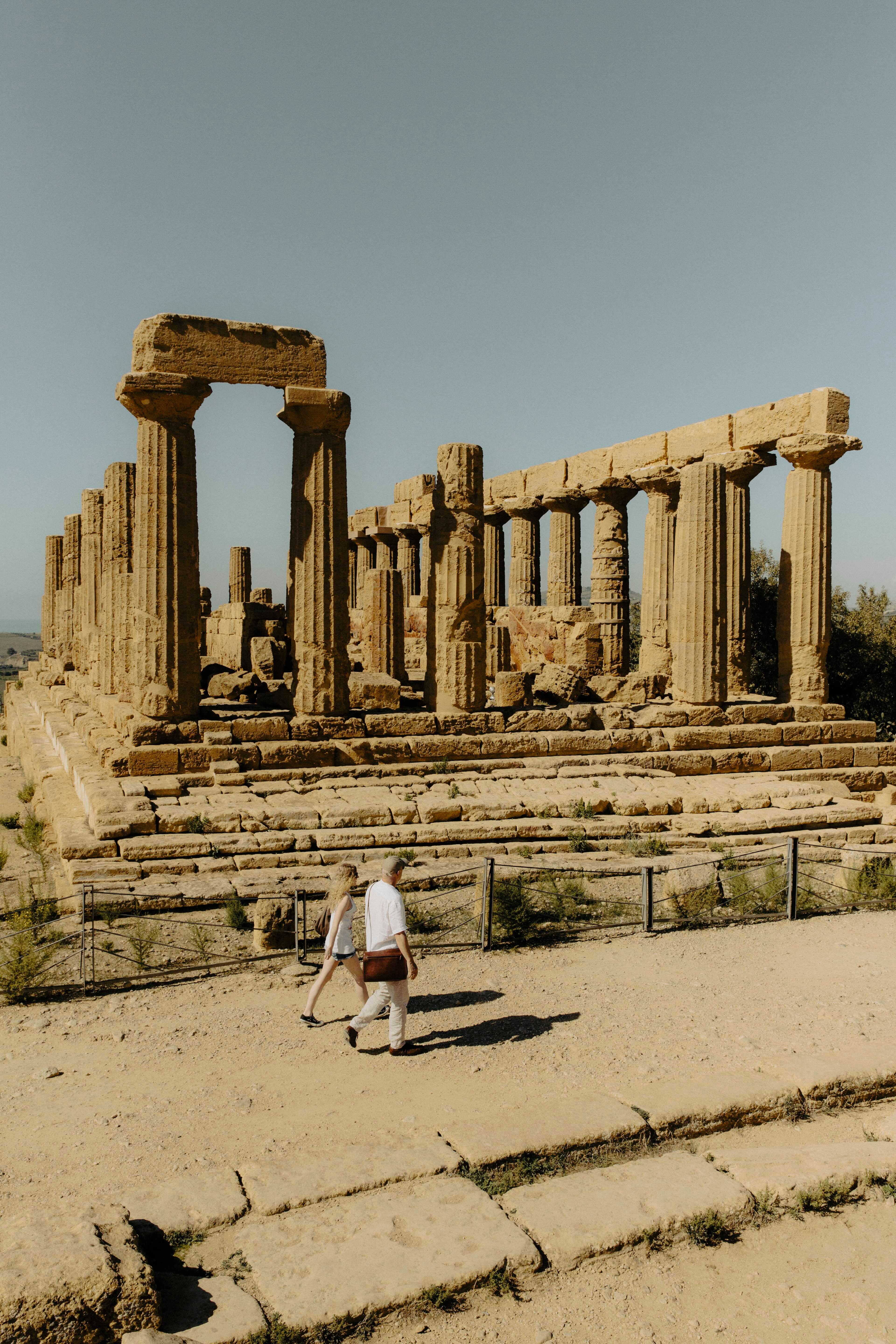 Tourists approaching the steps and columns of the Temple of Hera in Sicily