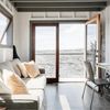 The living area of Phoenix House, with large patio doors looking out over the lava field at the base of Kīlauea volcano on Hawaii's Big Island