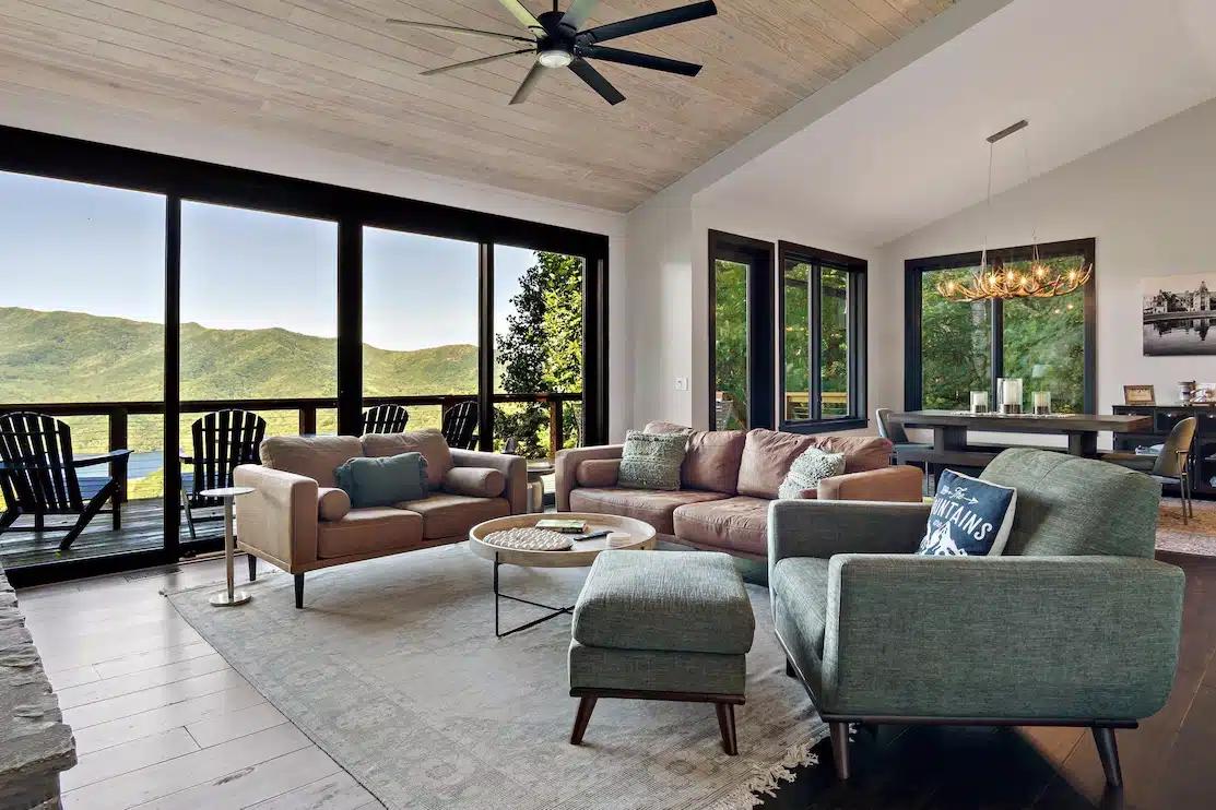 The modern living room of a Vrbo with views of Black Mountain, NC