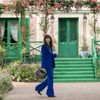 Lily Collins as Emily Cooper, walking in the grounds of Giverny, the former home of Claude Monet, in a scene from Emily in Paris
