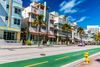 Pastel coloured art deco buildings line Ocean Drive on a bright sunny morning in South Beach.
