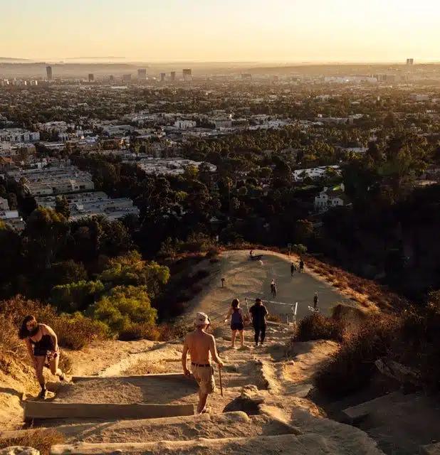 People hike up the stairs in Runyon Canyon overlooking the city of Los Angeles, California