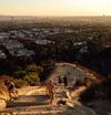 People hike up the stairs in Runyon Canyon overlooking the city of Los Angeles, California