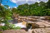 Richmond Falls surrounded by trees and rock formations in Swaledale, England.