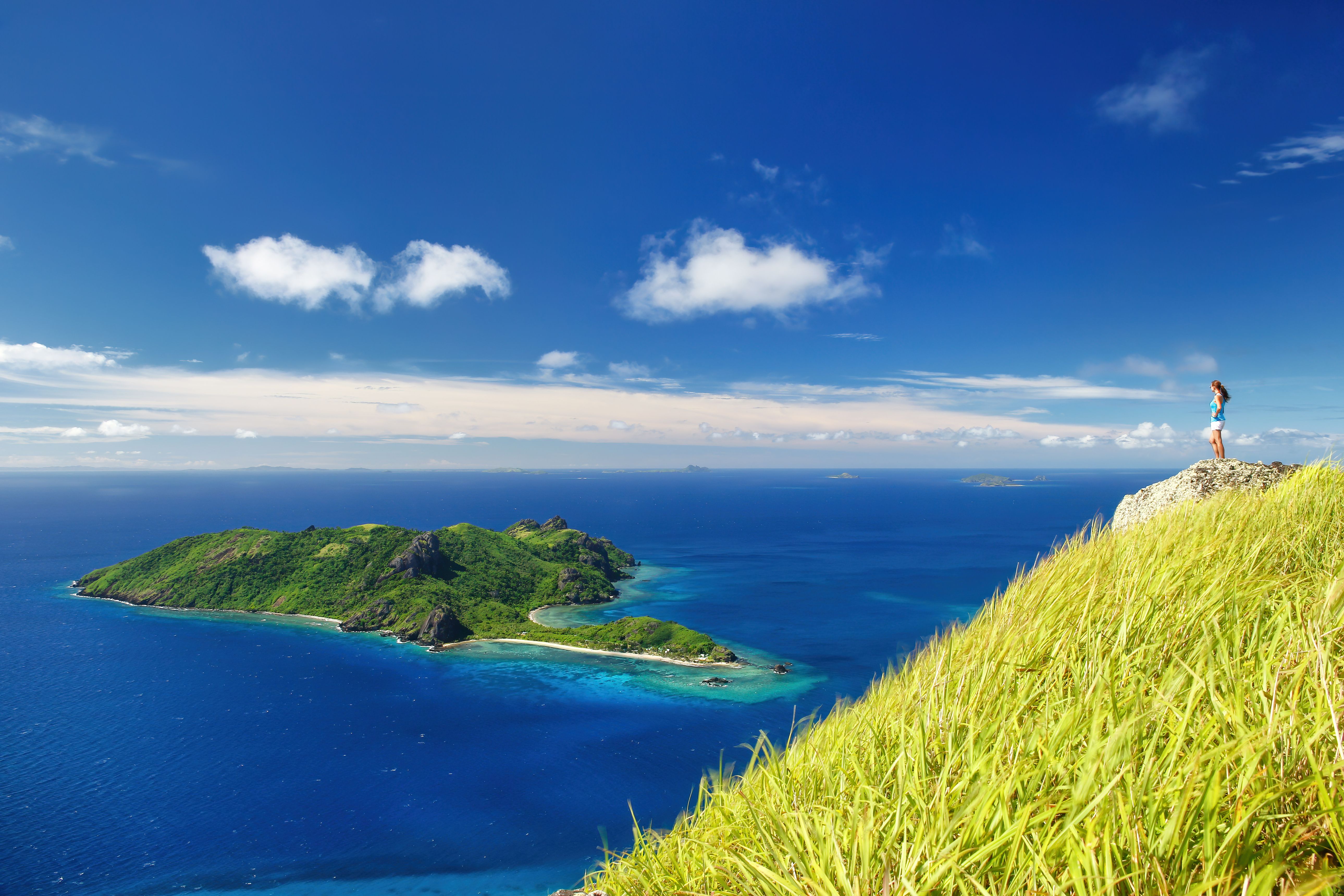 High above Fiji’s electric-blue lagoon, an island view that feels like the edge of the world.