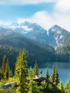 Trees and mountains surround a lake in North Cascades National Park, Washington