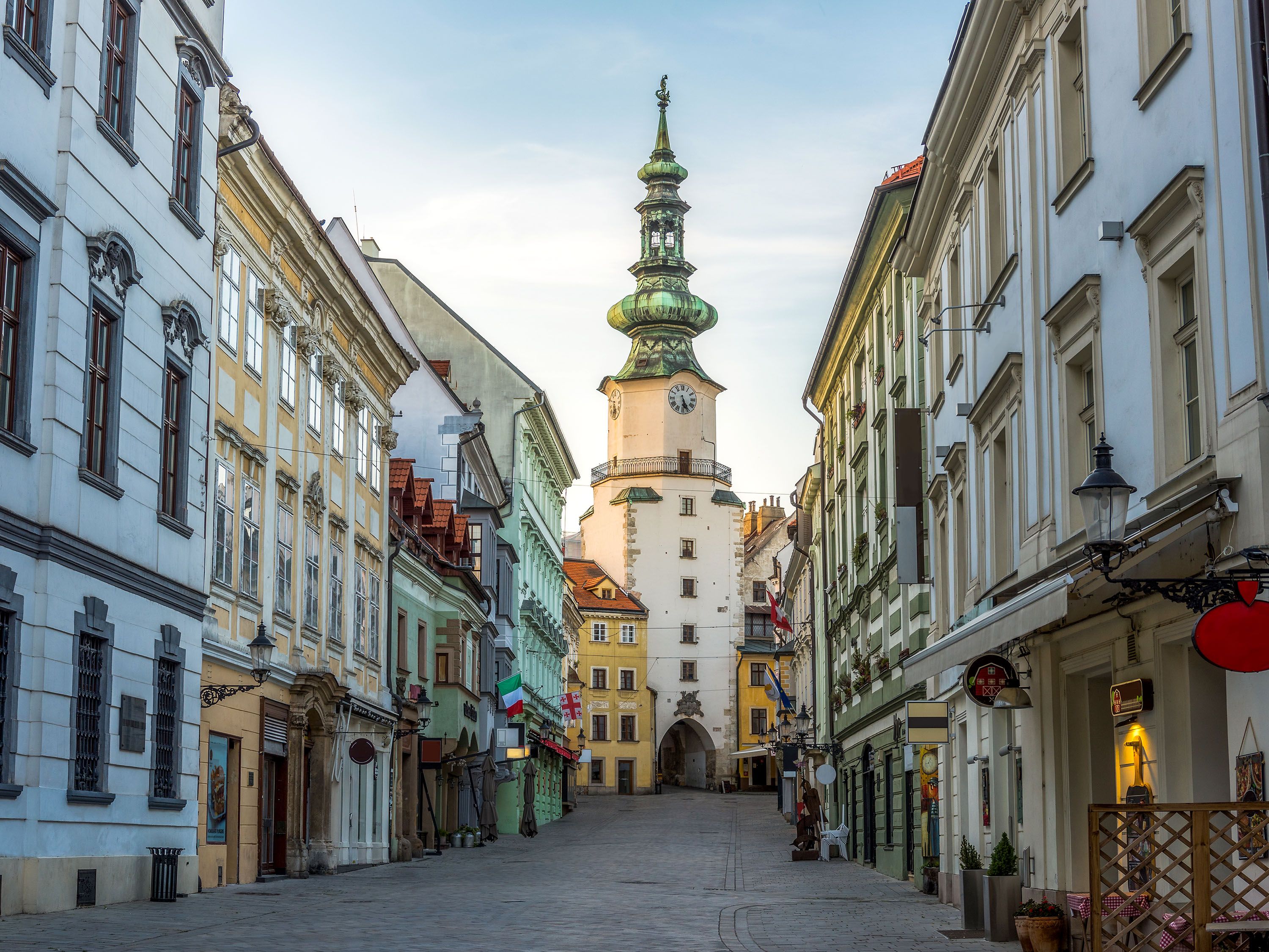 Colorful buildings  on street leading to a tower.