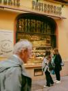 Two women look into the window of a boulangerie/patisserie in Nice, France