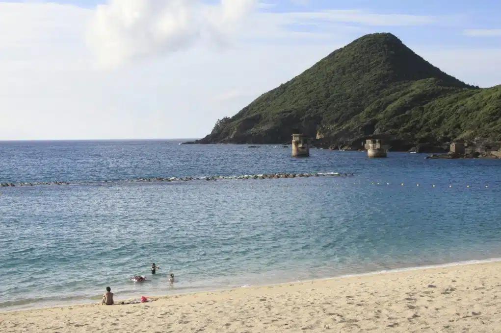People paddle in the calm waters of Isso Beach on Yakushima Island in Japan 