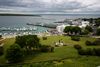 Looking down from Fort Mackinac on Mackinac Island with a view of rolling grassy hill to the port at the Straits of Mackinac between Lake Michigan and Lake Huron.