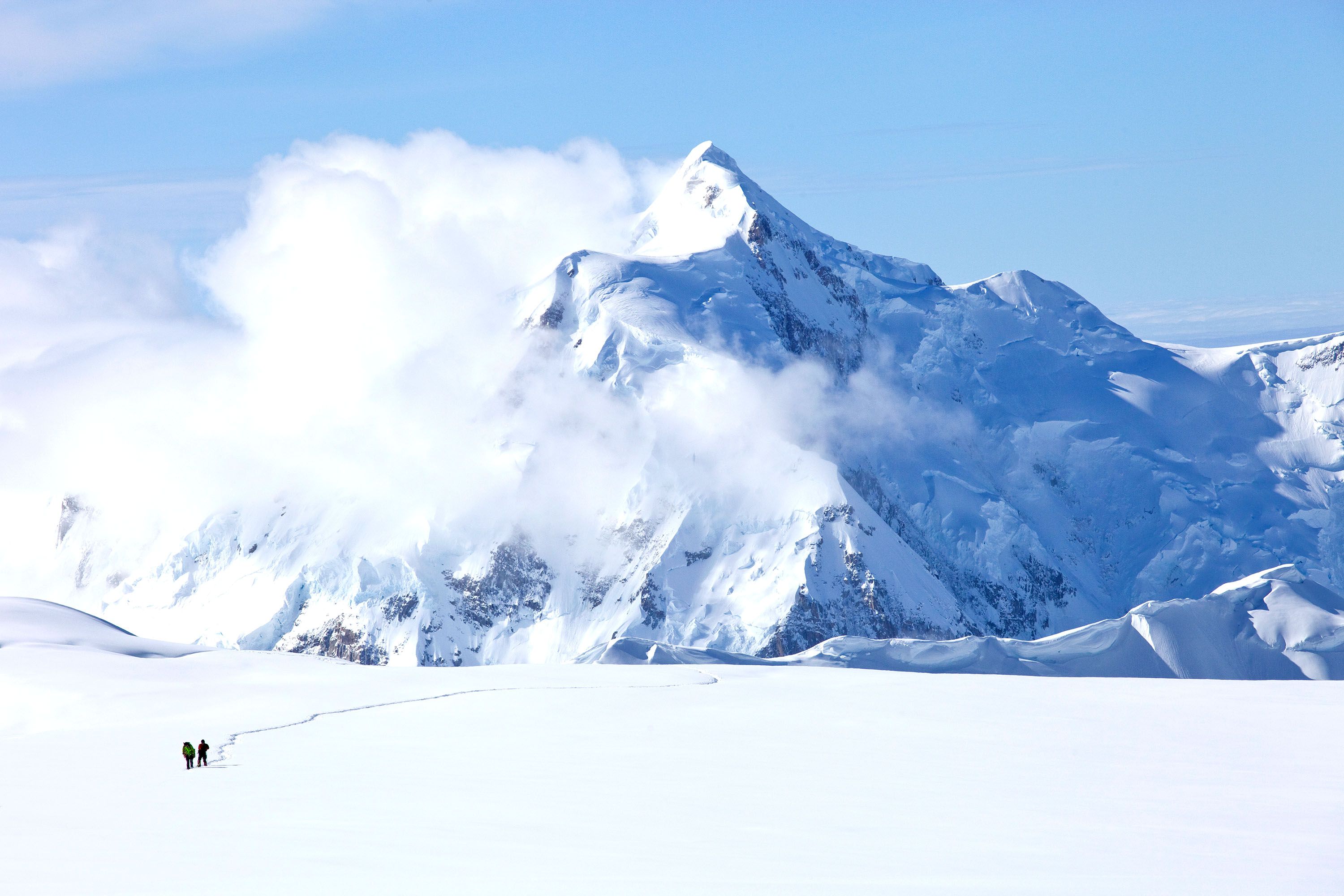 A snow-capped mountain peak surrounded by clouds.