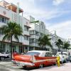 A red vintage Plymouth Belvedere car parked in Miami's Art Deco District