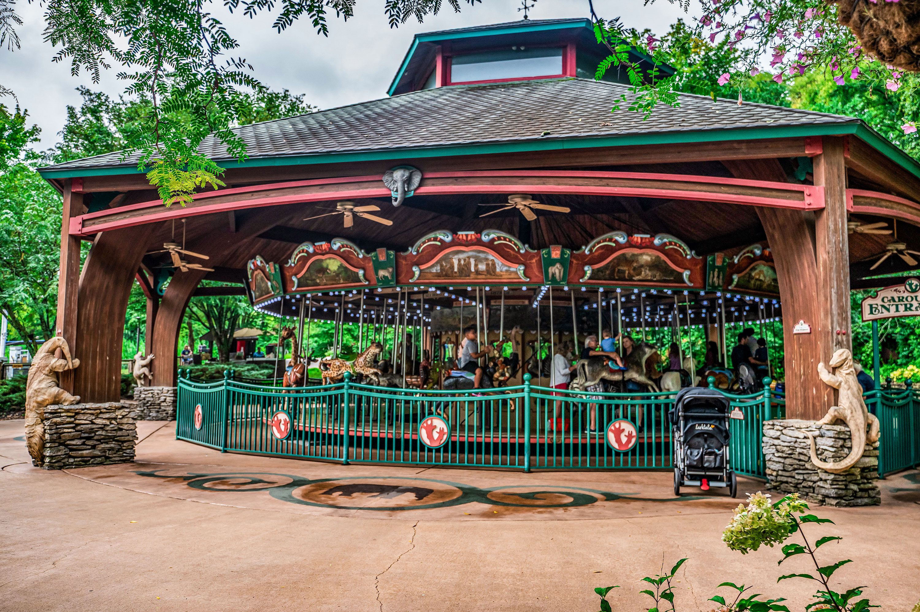 Jungle themed exterior merry-go-round with ceiling fans.