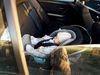 Window reflection and baby in car seat riding in a car.