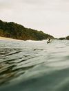 A surfer on a wave at San Pancho, Mexico