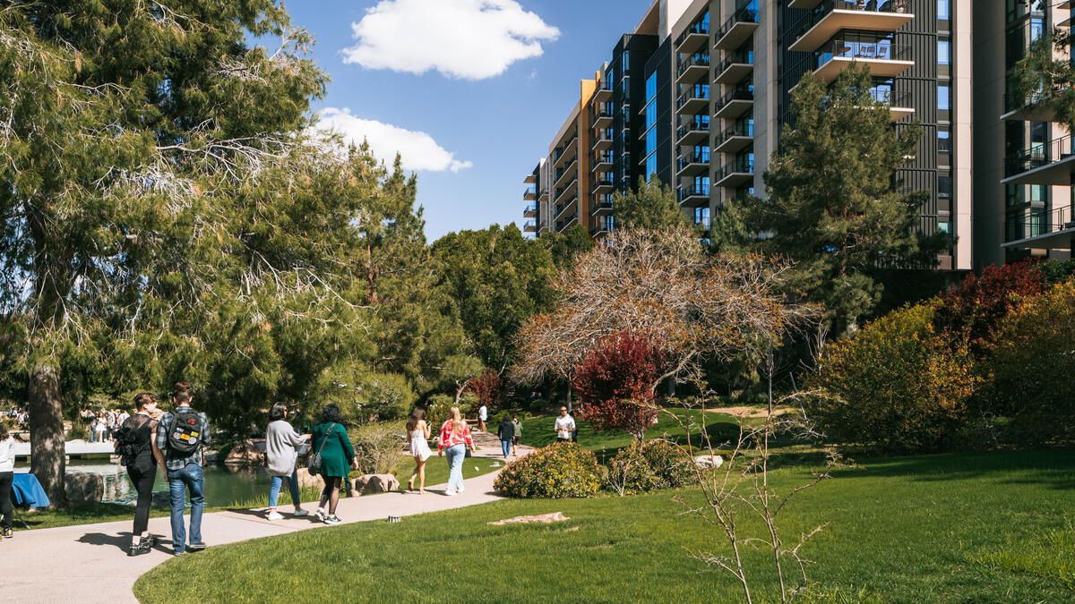 Visitors walk along a garden path beside a pond at the Japanese Friendship Garden in Phoenix.