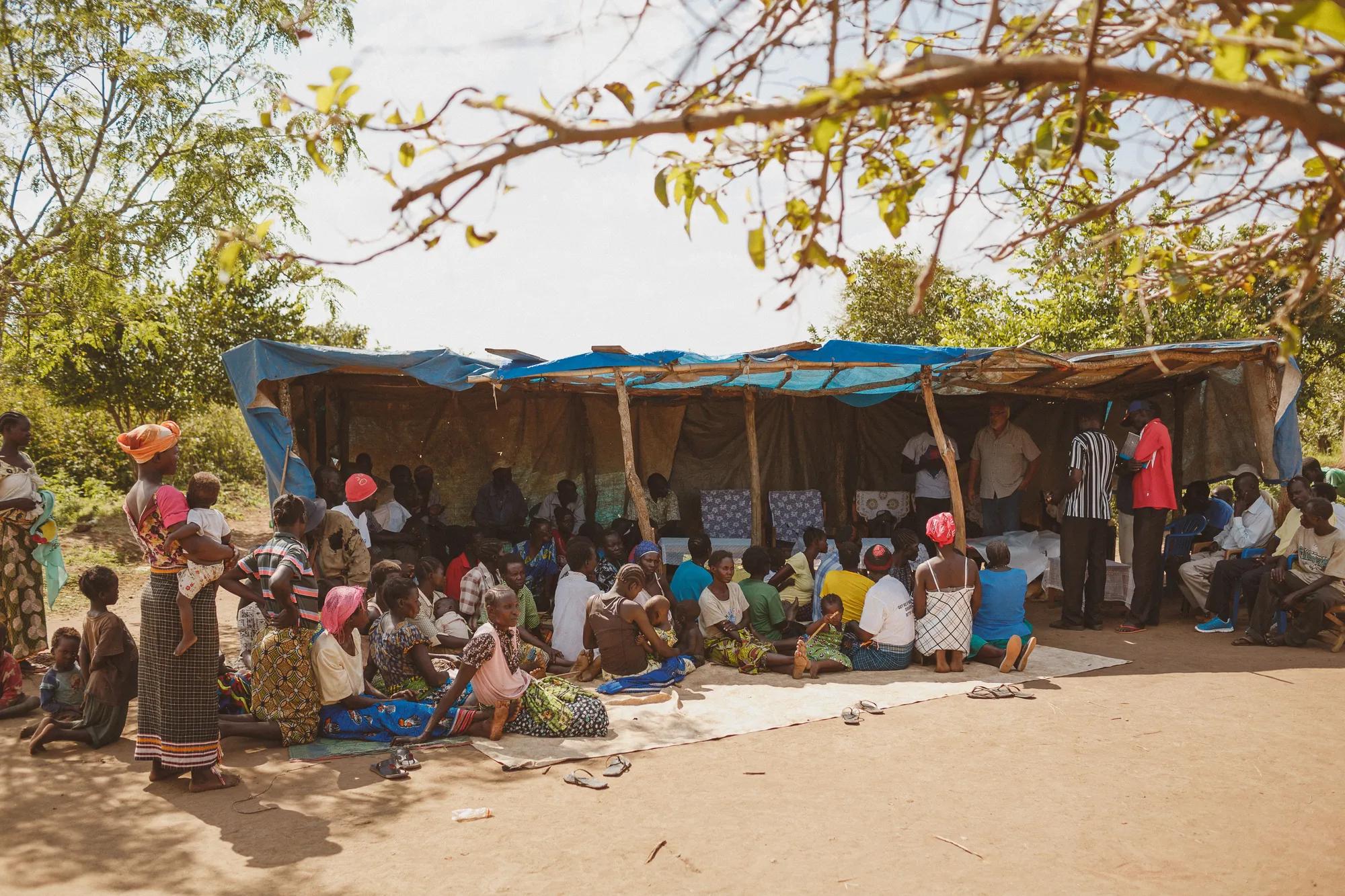 A village meeting about children missing school on market days