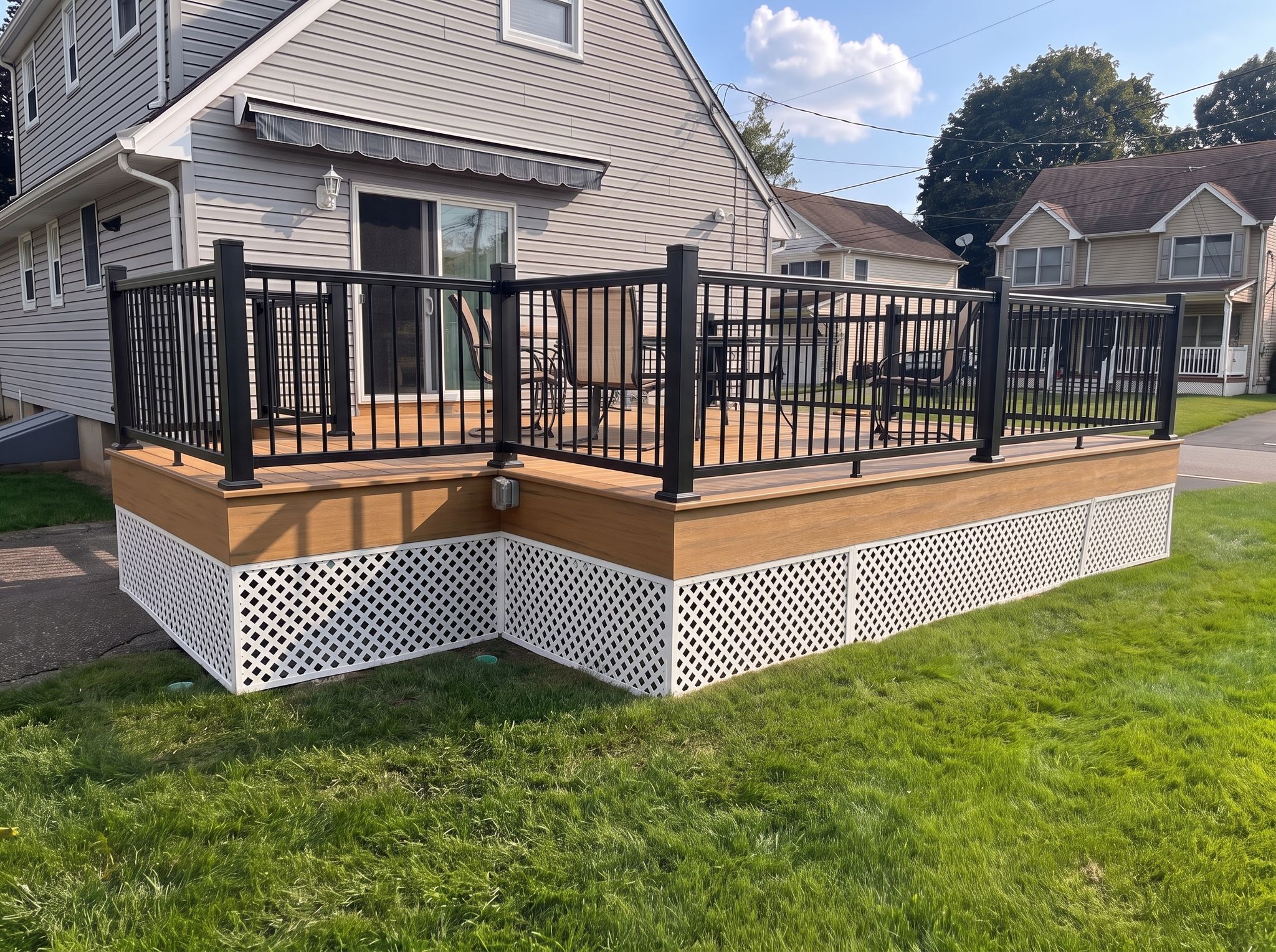 Deck with teak boards and black aluminum railings