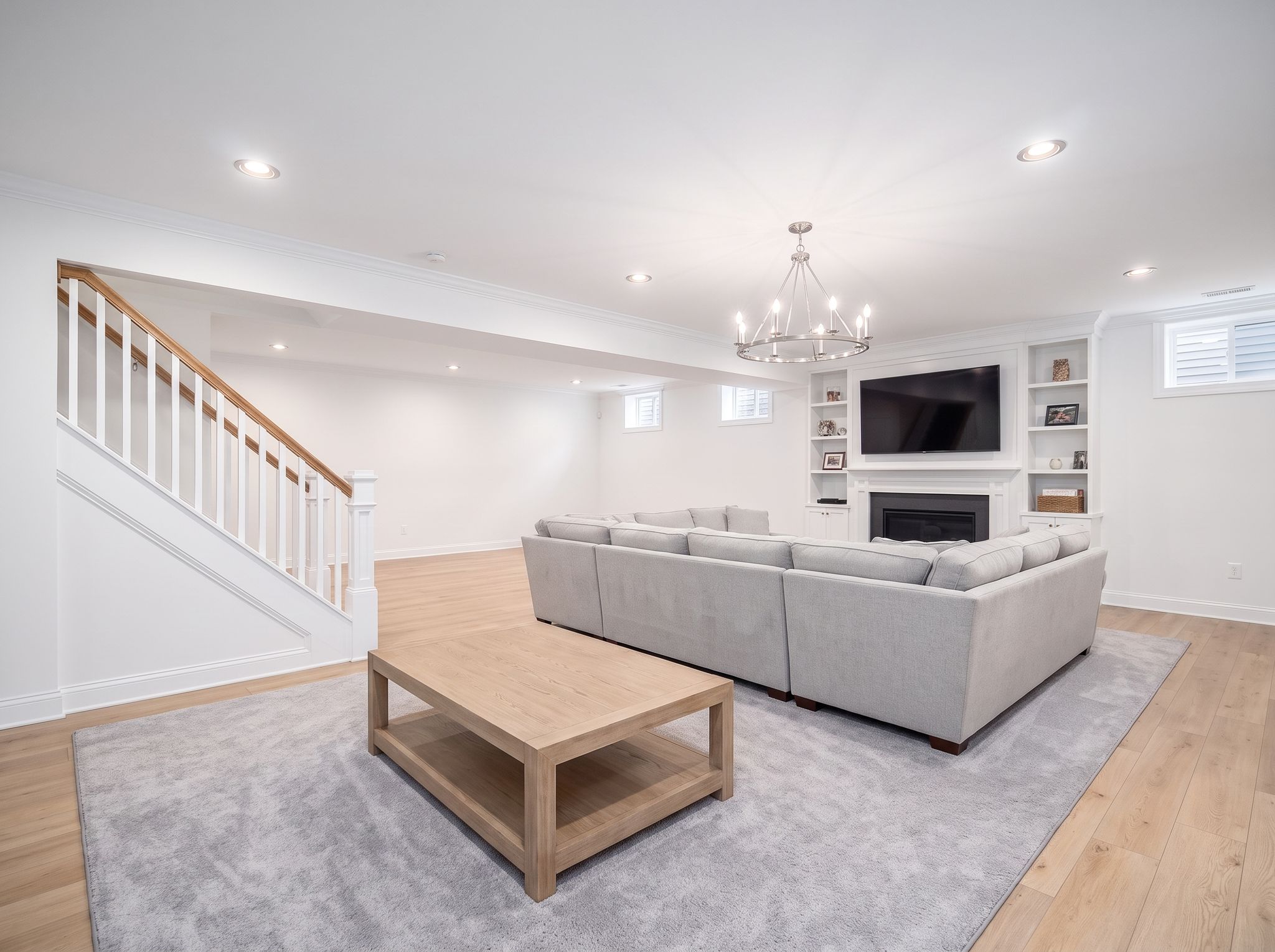 Finished basement family room in bright white